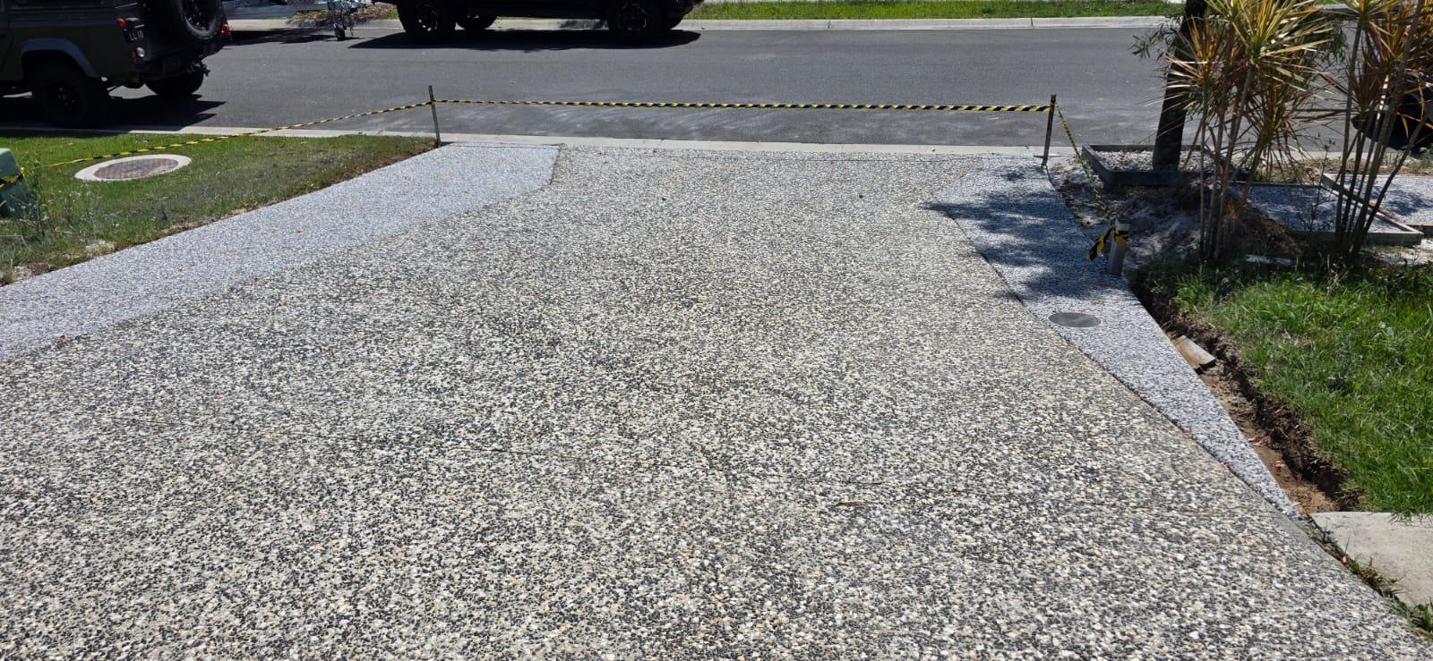 Crew pouring a reinforced concrete driveway