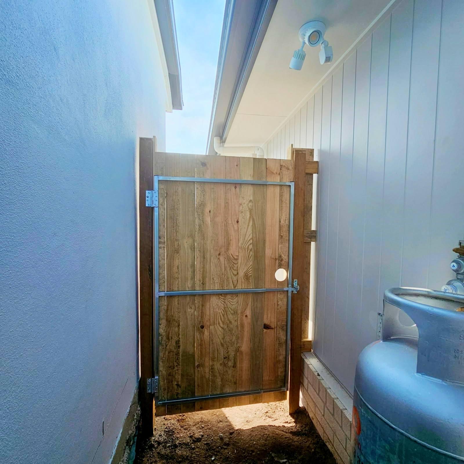 Team installing a pine timber gate for property security